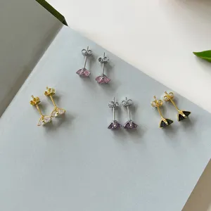 Detailed view of sterling silver star stud earrings with colorful cubic zirconia stones.