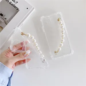 Clear phone case detail showing elegant pearl wrist chain design and transparent soft edge.