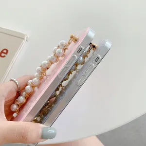 Detailed close-up of a dreamy pearl chain shell phone case with elegant acrylic texture.