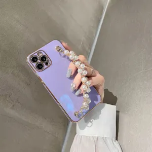 Detail shot showcasing the stylish purple electroplated phone case with a chic pearl chain strap.