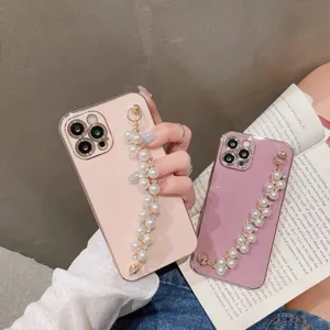 Detail view of electroplated solid color phone case featuring elegant pearl wrist chain.