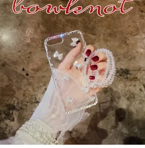 Clear rhinestone bow phone case detail with matching beaded strap and elegant crystal accents.