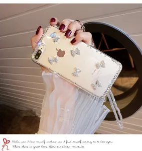 Clear luxury rhinestone bowknot phone case with crystal lanyard for iPhone protection.