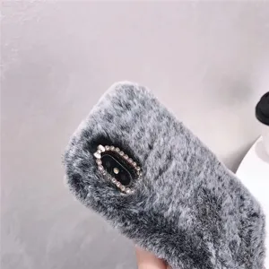 Grey plush phone case detail showing soft furry texture and rhinestone camera frame.