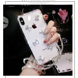 Cover per telefono trasparente con strass di lusso, fiocchi in cristallo e cinturino di perline.
