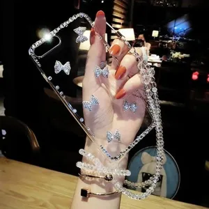 Transparent rhinestone bow phone case with beaded lanyard and metal bracelet for iPhone.