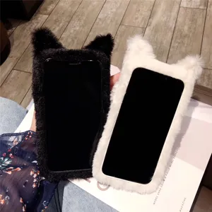 Detailed view of cute fluffy cat ear phone cases in black and white, plush texture lifestyle shot.