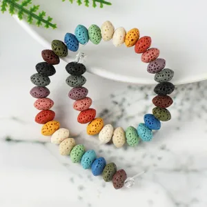 Close-up detail of colorful oval lava stone beads for DIY handmade jewelry crafting bracelets necklaces.