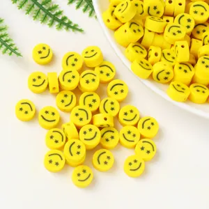 Yellow polymer clay smiley face beads with star eyes for DIY handmade jewelry making.