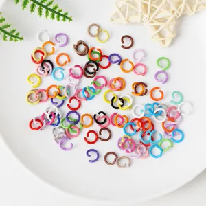 Colorful metal jump rings for handmade DIY jewelry making and craft accessories, top view flatlay.