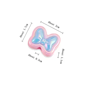 Detailed close-up view of the acrylic iridescent bow loose bead for DIY creations.