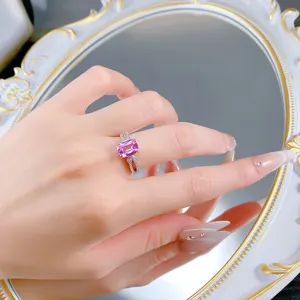 Detail view of a stunning cushion cut pink sapphire 925 silver ring with a chic bow design.