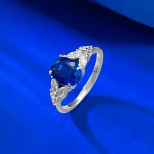 Detailed view of elegant S925 silver ring featuring royal blue oval stone and sparkling wing design.