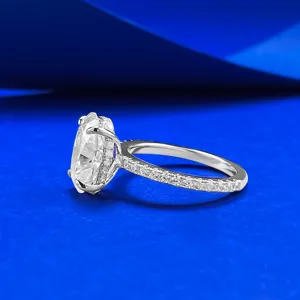 Close-up detail of the elegant oval moissanite ring with pave band and sparkling halo.