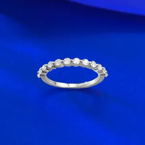 Detailed close-up view of a silver half eternity ring sparkling with small round stones.