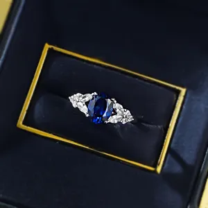 Exquisite S925 silver royal blue oval ring with wing design sparkling side stones detail view
