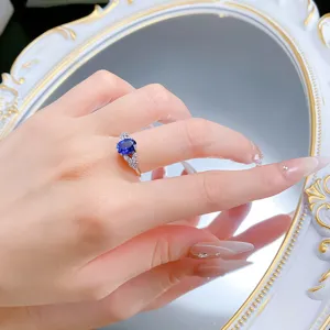 Stunning S925 silver oval royal blue sapphire ring with elegant wing design jewelry detail.