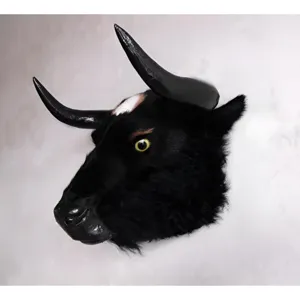 Detailed view of the black faux taxidermy bull head wall mount with large horns and yellow eye.