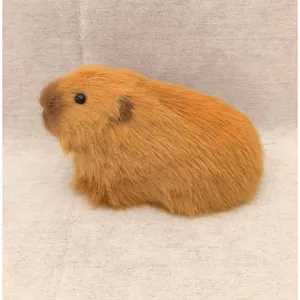 Close-up detail view of a cute simulation capybara plush toy ornament with soft brown fur texture.