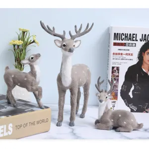 Detailed view of flocked simulated deer figurine set, perfect for desktop Christmas decor.