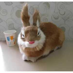 Closeup of simulation brown white rabbit plush figurine, realistic fluffy animal decor.