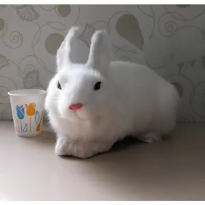 Detailed close-up view of the white plush rabbit figurine with realistic fur texture.