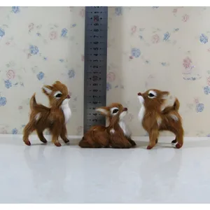 Detailed view of miniature faux fur deer figurines with size scale ruler for display.