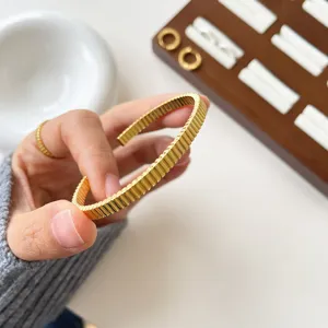 Goldfarbenes geriffeltes offenes Armband, exquisites strukturiertes Manschetten-Schmuckstück.