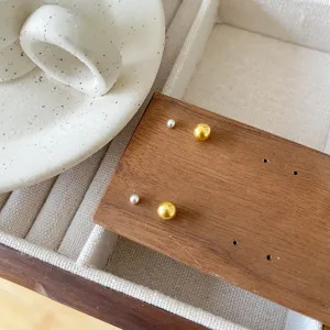 Minimalist tiny ball stud earrings detail view, dainty silver and gold minimalist design