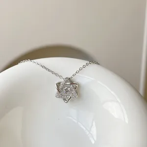Sterling silver hexagram necklace detail, sparkling dancing stone pendant, elegant clavicle chain.