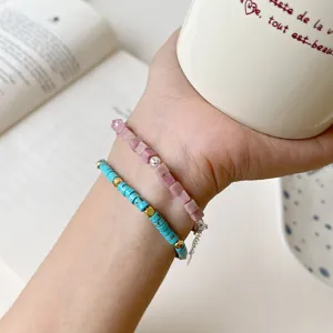 Charming turquoise and rhodochrosite beaded bracelets stack, sterling silver details, detail shot.