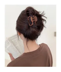 Detail view of a stylish matte brown square hair claw clip, perfect for chic half up hairstyles.