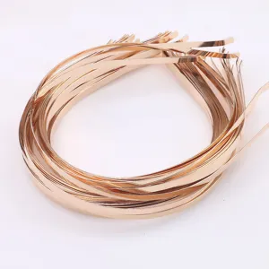Detail shot of metal headband blanks for DIY crafts, gold finish hair hoop base, jewelry supplies.