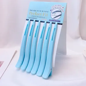 Detail shot of light blue non-crease duckbill hair clips with silicone pad for styling.