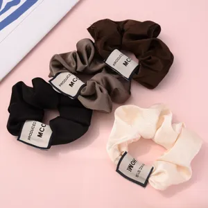Detailed view of trendy vintage solid color fabric hair scrunchies set for women styling.