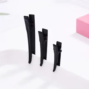 Detail view of black metal duckbill hair clips set, multi-size hair styling accessory.