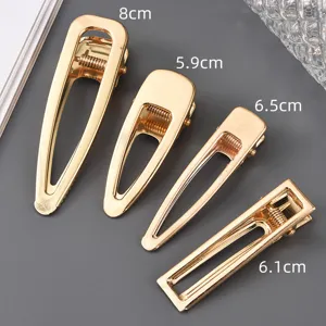 Set of four geometric metal hair clips in various sizes, elegant gold finish for women styling.