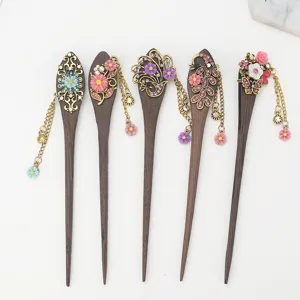 Handmade wooden hair stick with vintage metal floral rhinestone tassel design for elegant bun.