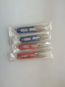 Detail view of colorful U-shaped thread scissors in clear packaging, ideal for sewing tasks.