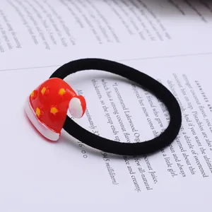 Santa hat hair tie detail shot, cute black elastic hair rope with red Christmas hat.