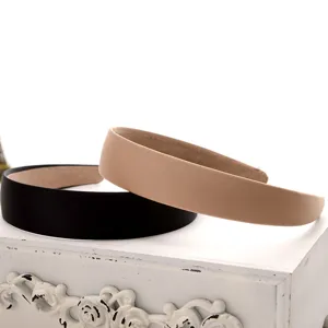 Detail shot of solid color velvet headbands in black and nude, stylish daily hair accessories.