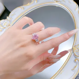 Stunning pink oval high-carbon diamond ring set in sterling silver with exquisite side stones.