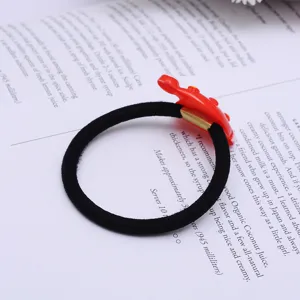 Cute red cartoon hair tie detail close-up, sweet style daily hair accessory for girls and women.