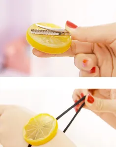 Closeup detail of cute lemon slice hair clip and elastic hair tie, fresh sweet fruit design.