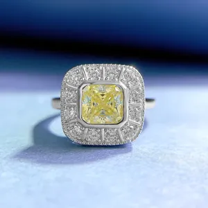 Macro detail of 1ct square yellow diamond ring in 925 silver with sparkling halo.