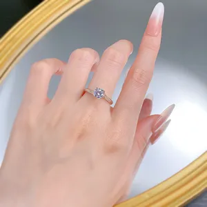 Exquisite four-prong solitaire ring detail shot, classic design, elegant finger wear display.