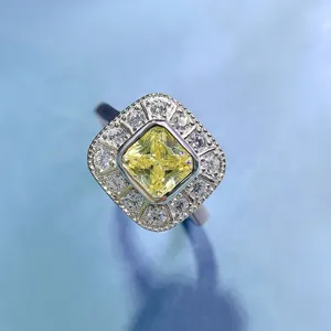 Macro close-up of a stunning 1ct square yellow diamond halo ring with fine silver band.
