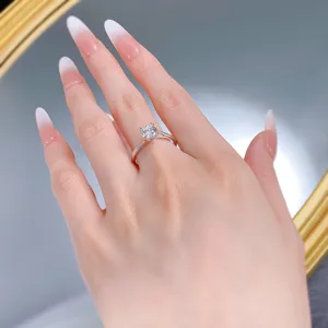 Detailed shot of a classic four-prong solitaire ring on a hand model, featuring a brilliant stone.