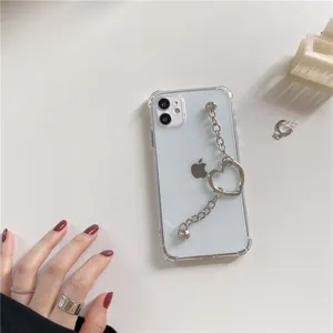 Clear protective phone case detail featuring a fashionable silver metal heart chain wrist strap.