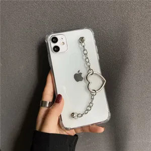 Clear iPhone case detail showcasing elegant silver heart chain wrist strap and transparent design.
